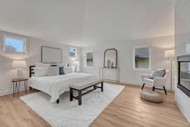 bedroom with light wood-style flooring and baseboards