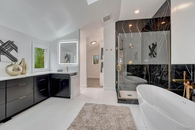 bathroom featuring a stall shower, a soaking tub, vanity, lofted ceiling, and recessed lighting