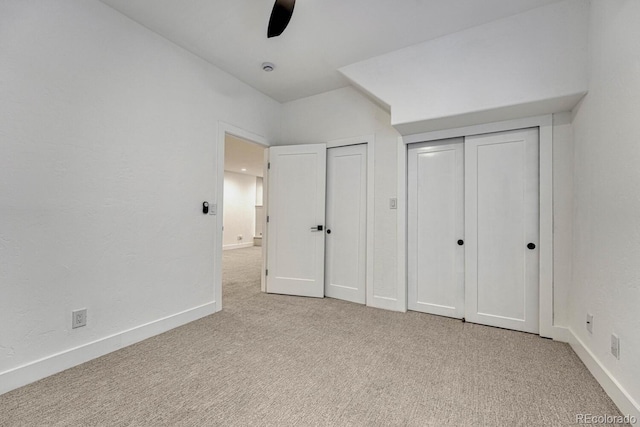 unfurnished bedroom featuring carpet floors, baseboards, and ceiling fan