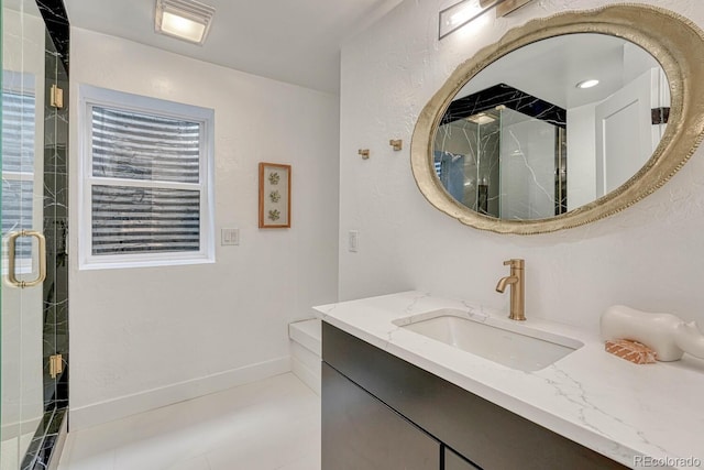 bathroom with a stall shower and vanity