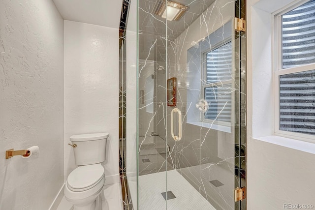 full bathroom with toilet, a marble finish shower, and a textured wall