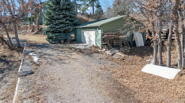 detached garage with dirt driveway