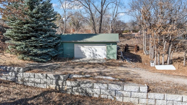 view of outbuilding featuring a garage and driveway