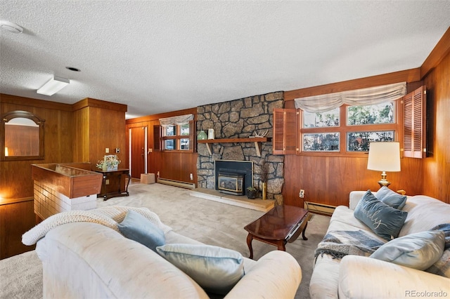 living room with wooden walls, a baseboard heating unit, a fireplace, and a textured ceiling