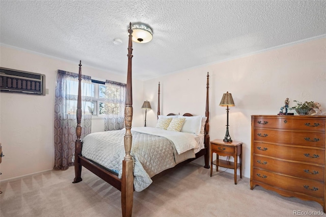 bedroom with light colored carpet, a wall unit AC, and a textured ceiling