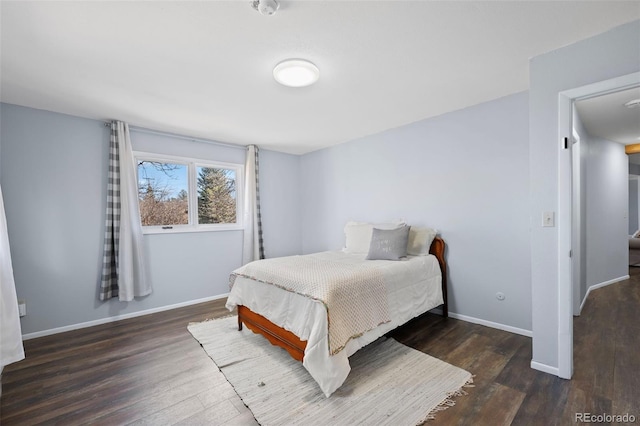 bedroom with wood finished floors and baseboards