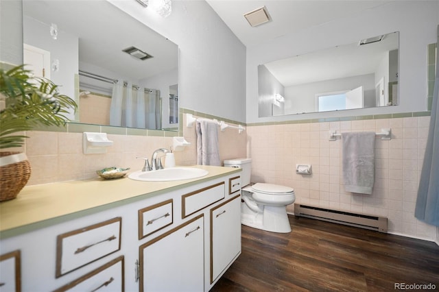 full bathroom featuring toilet, wood finished floors, visible vents, tile walls, and baseboard heating