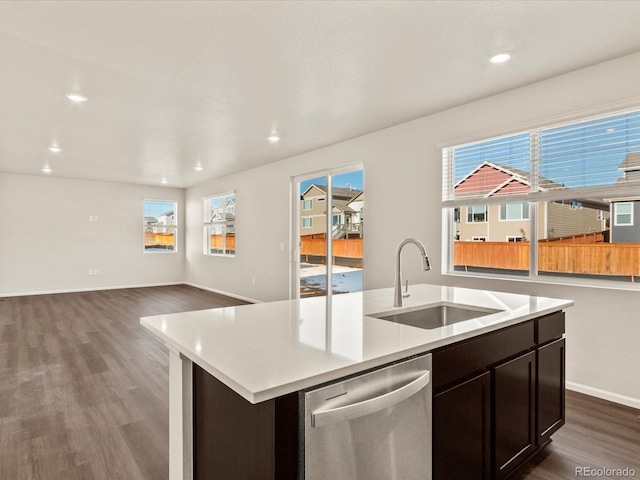 kitchen featuring sink, dark hardwood / wood-style floors, dishwasher, and a center island with sink