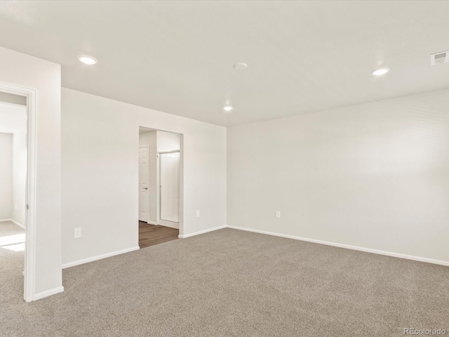 empty room featuring dark colored carpet