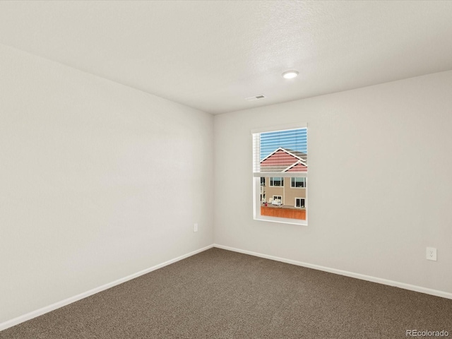 unfurnished room featuring carpet flooring