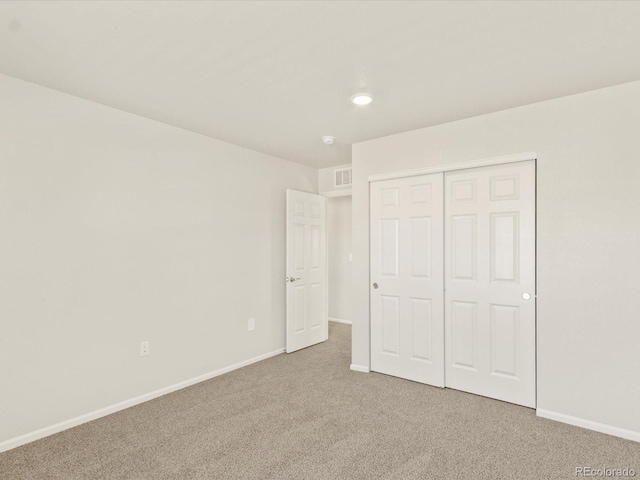 unfurnished bedroom featuring a closet and carpet