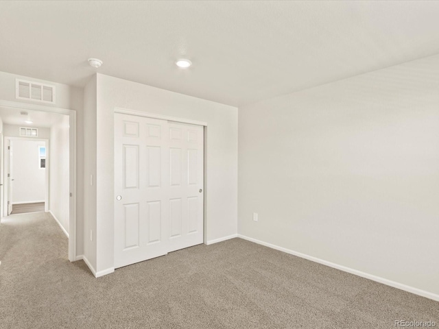 unfurnished bedroom featuring a closet and carpet flooring