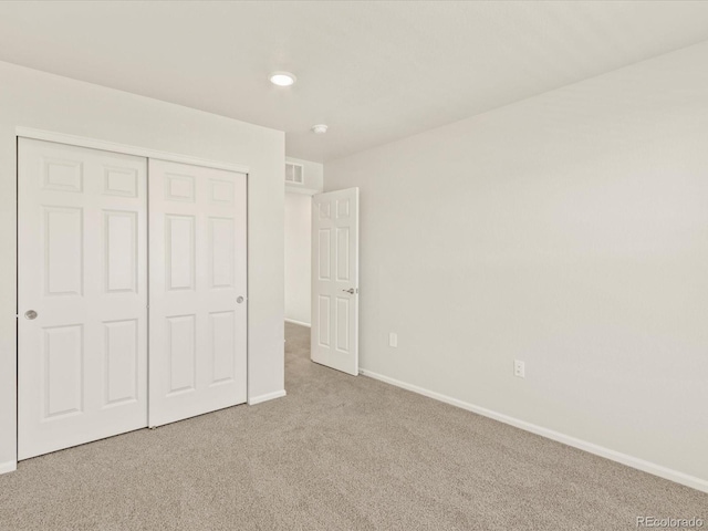 unfurnished bedroom featuring a closet and carpet