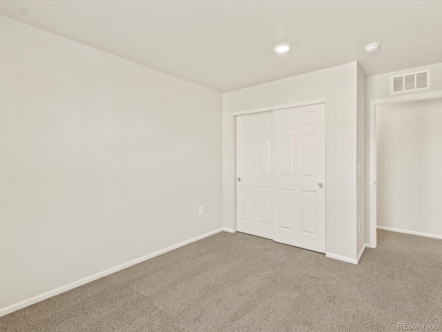 unfurnished bedroom with carpet floors and a closet