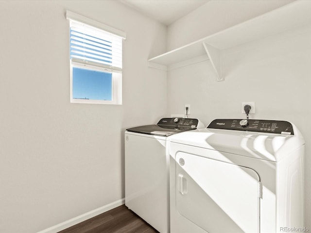 laundry room with dark hardwood / wood-style flooring and washing machine and dryer