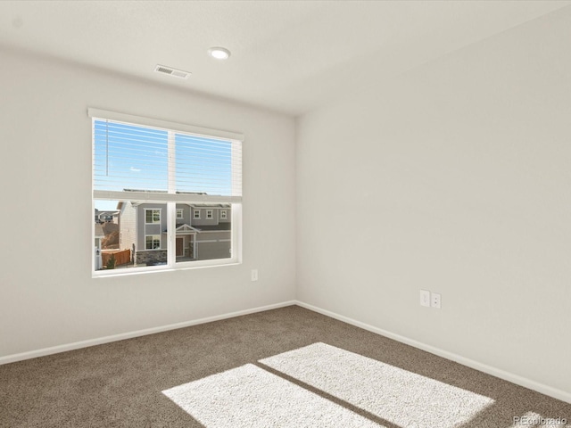 empty room with dark colored carpet