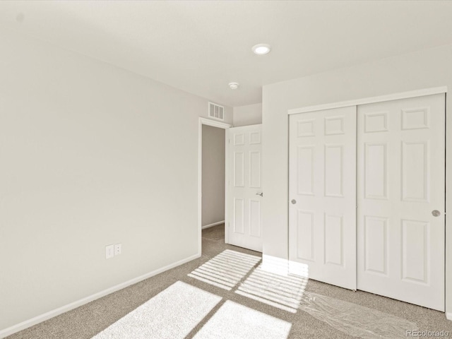 unfurnished bedroom with a closet and carpet floors