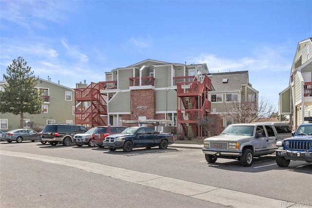 view of building exterior featuring uncovered parking