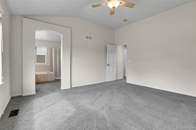 10115 Foxridge Ct, Highlands Ranch, CO 80126 - unfurnished bedroom featuring arched walkways, carpet floors, vaulted ceiling, a ceiling fan, and connected bathroom