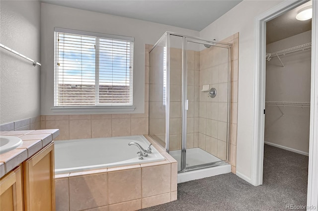 10115 Foxridge Ct, Highlands Ranch, CO 80126 - full bathroom featuring a shower stall, a bath, vanity, and a walk in closet