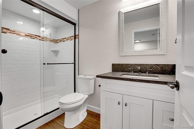10115 Foxridge Ct, Highlands Ranch, CO 80126 - bathroom with vanity, a shower stall, wood finished floors, and a textured wall