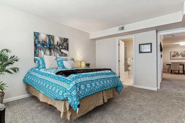 carpeted bedroom with ensuite bath