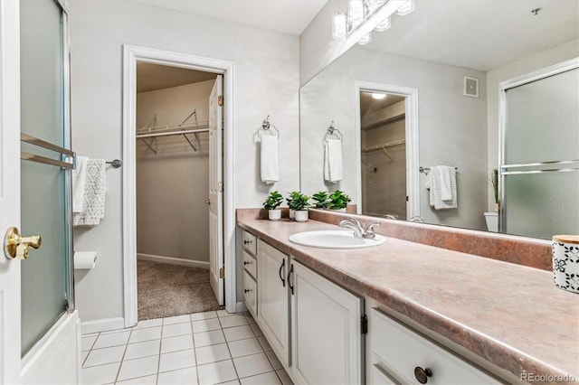 bathroom with tile patterned flooring, vanity, toilet, and an enclosed shower