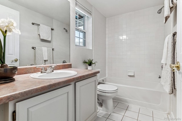 full bathroom with tile patterned floors, vanity, tiled shower / bath combo, and toilet