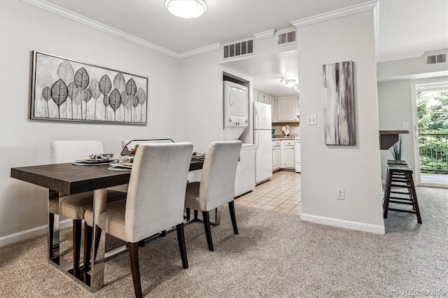 dining area with light colored carpet and crown molding