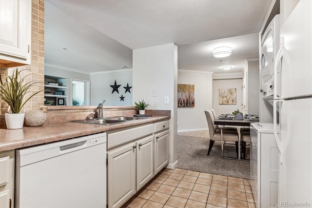 kitchen featuring light carpet, sink, white cabinets, and white appliances