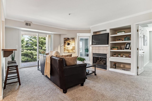 living room with built in shelves, crown molding, a fireplace, and carpet