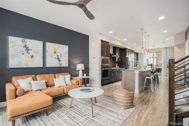 9072 E 47th Ave, Denver, CO 80238 - living area with stairs, light wood finished floors, recessed lighting, ceiling fan, and baseboards
