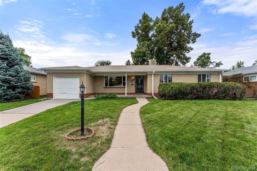 ranch-style home with a front lawn and a garage