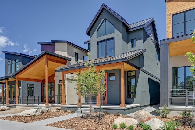 414 E Arkansas St, Buena Vista, CO 81211 - contemporary house featuring a standing seam roof, covered porch, a metal roof, and stucco siding
