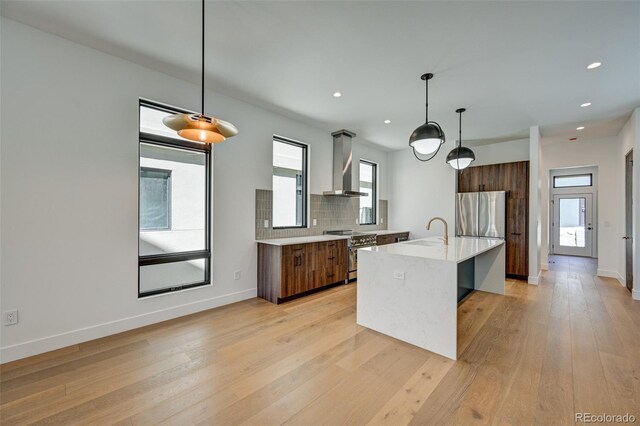 414 E Arkansas St, Buena Vista, CO 81211 - kitchen with wall chimney exhaust hood, modern cabinets, stainless steel appliances, light countertops, and recessed lighting