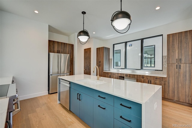 414 E Arkansas St, Buena Vista, CO 81211 - kitchen with appliances with stainless steel finishes, light wood-style flooring, modern cabinets, light countertops, and blue cabinets