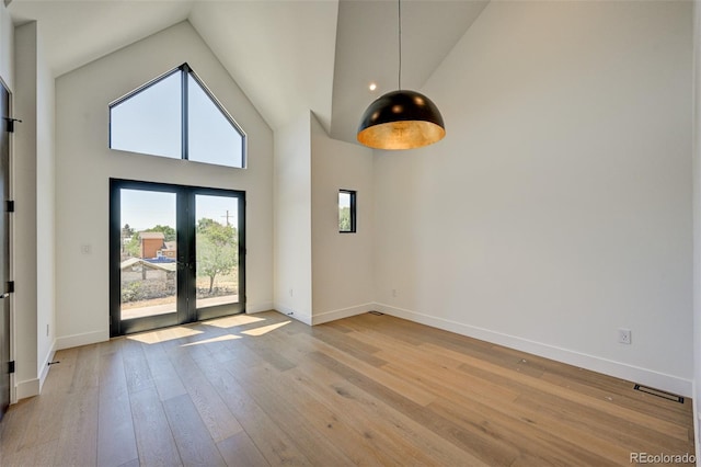414 E Arkansas St, Buena Vista, CO 81211 - spare room with light wood-style flooring, high vaulted ceiling, and french doors