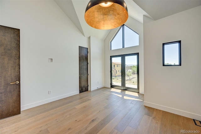 414 E Arkansas St, Buena Vista, CO 81211 - unfurnished room with wood finished floors, high vaulted ceiling, and french doors