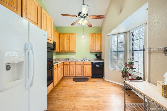 kitchen with a ceiling fan, light brown cabinetry, white fridge with ice dispenser, black dishwasher, and light wood-style flooring