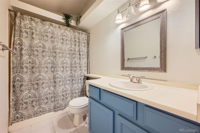 full bathroom with vanity, tile patterned flooring, toilet, and curtained shower