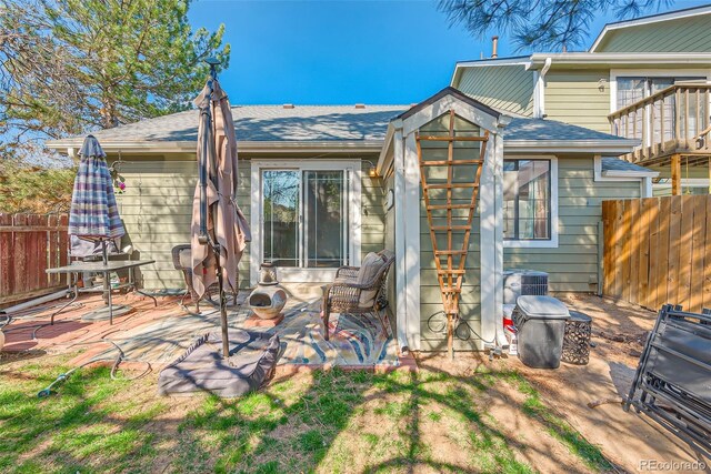 back of house with a patio, fence, a shingled roof, and cooling unit