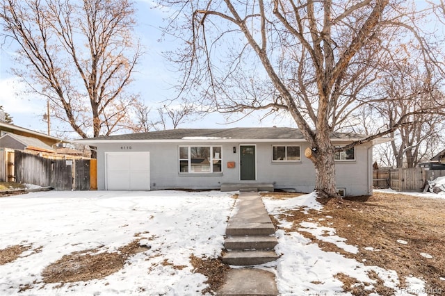 ranch-style home featuring an attached garage, fence, and brick siding