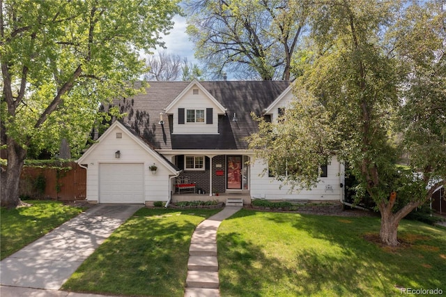 view of front of property featuring driveway, an attached garage, covered porch, and roof with shingles