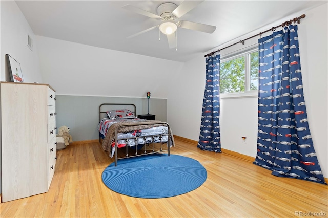 bedroom with wood finished floors, baseboards, and a ceiling fan