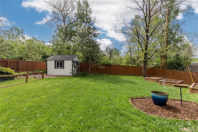 view of yard featuring a vegetable garden, a storage shed, and an outdoor structure