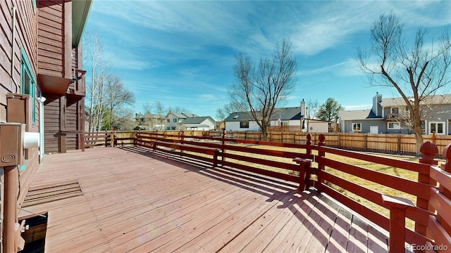 wooden deck with a residential view and fence