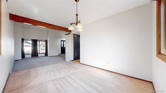 empty room featuring a chandelier, light colored carpet, beamed ceiling, and baseboards