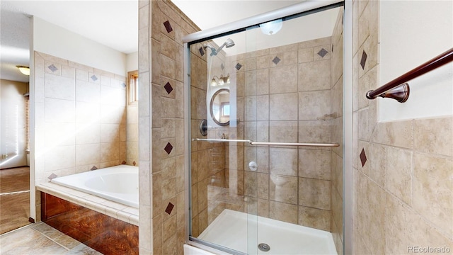 bathroom with a garden tub and a shower stall