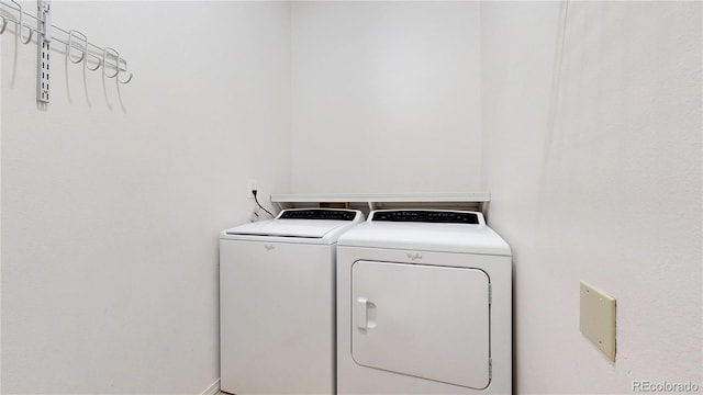 laundry room with washer and dryer and laundry area