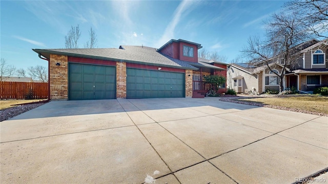 view of front of house with a garage, concrete driveway, brick siding, and fence